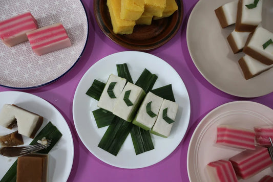 Assorted traditional desserts on plates with a purple background