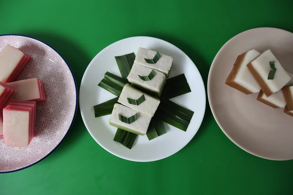 Three plates with different types of food on a green background