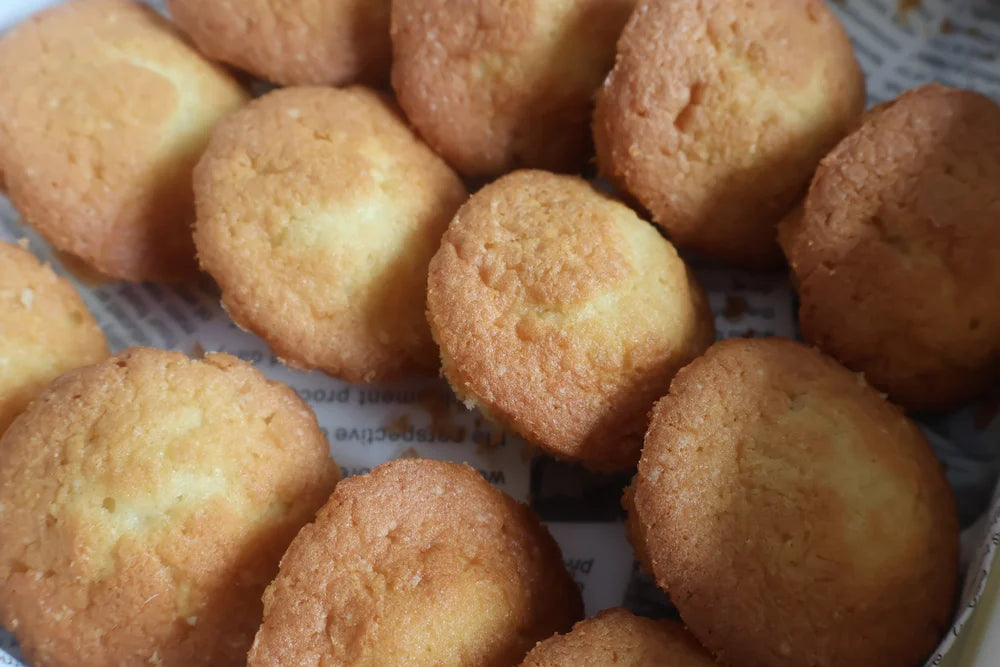 Close-up of round, golden-brown baked goods on a textured surface
